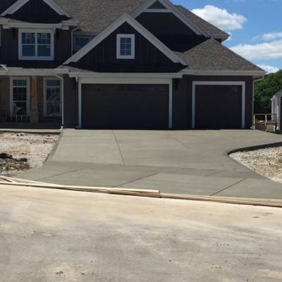 Decorative concrete driveway installation in Waukesha showcases modern home design and curb appeal